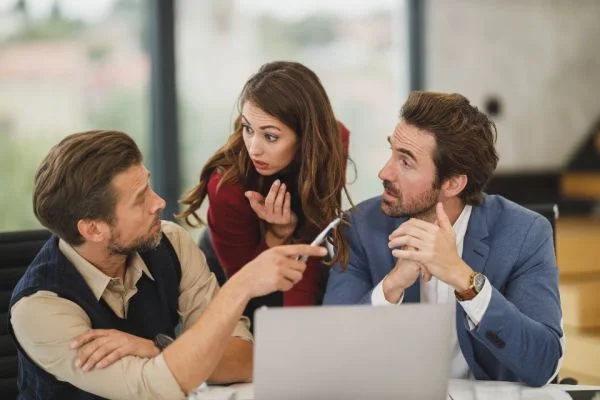 Campaign planning discussion around a laptop